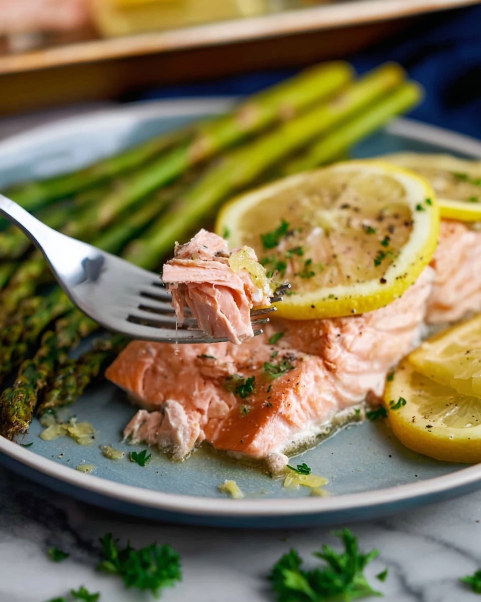 A close-up photo shows a piece of pink cooked salmon held on the tines of a fork above a white plate with a blue inner surface. The salmon is topped with lemon slices and sprinkled with herbs and black pepper. On the plate, next to the salmon, there is a serving of green asparagus stalks. Lemon wedges and some green parsley are visible around the plate on a white marbled surface. The photo is detailed, highlighting the soft texture of the salmon and the fresh pulled-apart flakes. photo taken with an iphone --ar 4:5 --v 7