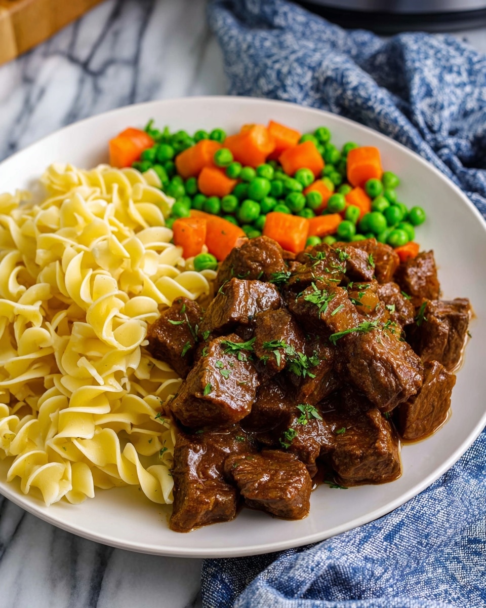 The dish shows a white plate filled with three main parts. On the left side, there is a pile of yellowish twisted egg noodles with a smooth texture. In the middle, there is a big heap of brown beef cubes with a shiny sauce coating and small bits of cooked onion and green herbs sprinkled on top. On the right side, there is a mix of bright orange carrot chunks and green peas, each piece clearly separated. The plate is set on a white marbled surface with a blue and white cloth partially under it, adding a cozy touch. Photo taken with an iphone --ar 4:5 --v 7