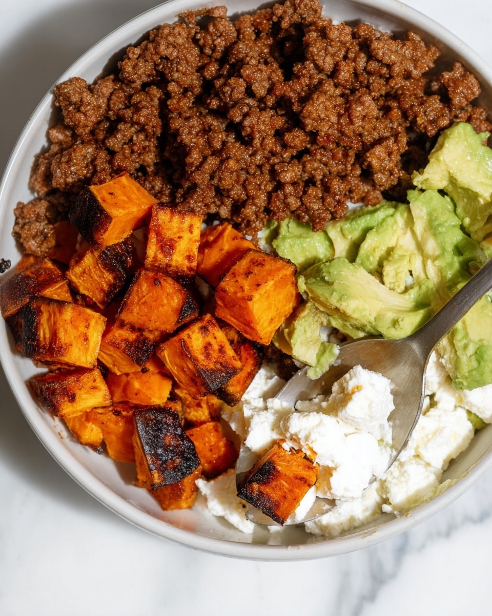 A close-up image of a bowl showing four main layers of food arranged side by side. On the top left, there is cooked ground beef with a rich brown color and a slightly oily texture. On the bottom left, there are small cubes of roasted sweet potatoes with a deep orange color and some charred black spots, giving a crispy look. On the right side, there are creamy white cottage cheese curds mixed with chunks of light green avocado. A metal spoon is scooping some of the cottage cheese and avocado mix. The bowl is white, and the background has a white marbled texture. Photo taken with an iphone --ar 4:5 --v 7