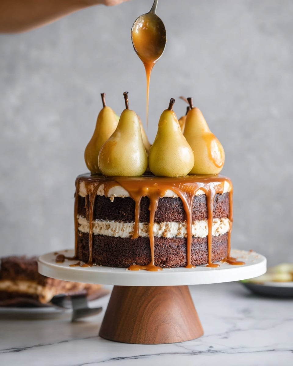 The cake has three visible layers of dark brown chocolate sponge separated by light cream filling, all covered with a glossy caramel sauce dripping down the sides. On top, there are four whole poached pears with a smooth, light yellow surface, sitting right in the center of the cake. A spoon held by a woman's hand is pouring more caramel sauce over the pears. The cake is placed on a white plate with a wooden cake stand beneath it, with a white marbled surface in the background. Photo taken with an iphone --ar 4:5 --v 7