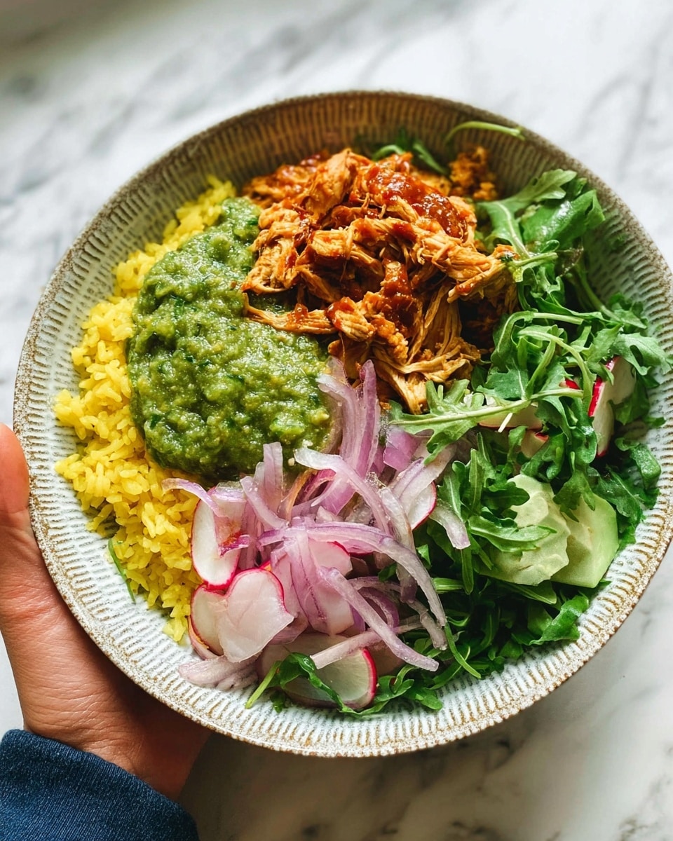 A blue patterned bowl holds a colorful layered dish, starting with a base of bright yellow rice on one side. On top of the rice, there is a chunky green pesto-like sauce and a smooth, light green guacamole beside it. Next to the sauces, shredded orange-brown chicken is placed on the right side of the bowl. At the top, there is a fresh layer of mixed greens including arugula and thinly sliced pink and white radishes, with some thin red onion slices adding a pop of color in the center. The bowl is held by a woman's hand, and the background shows a white marbled texture. photo taken with an iphone --ar 4:5 --v 7