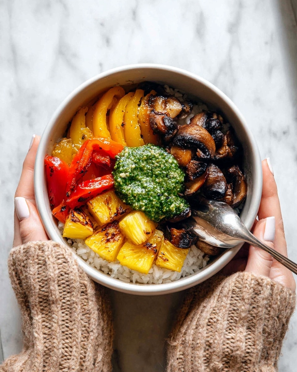 A bowl with three main layers is held by a woman's hand wearing a knitted beige sweater, with a silver spoon inside. The base layer is white rice, visible under the toppings. On top, there are three sections: caramelized yellow and red bell pepper slices on the left, golden brown grilled pineapple chunks at the bottom, and dark brown sautéed mushrooms with a shiny texture on the right. In the center, there is a generous dollop of bright green pesto sauce, creating a vibrant contrast. The bowl itself is white, placed against a white marbled background. Photo taken with an iphone --ar 4:5 --v 7